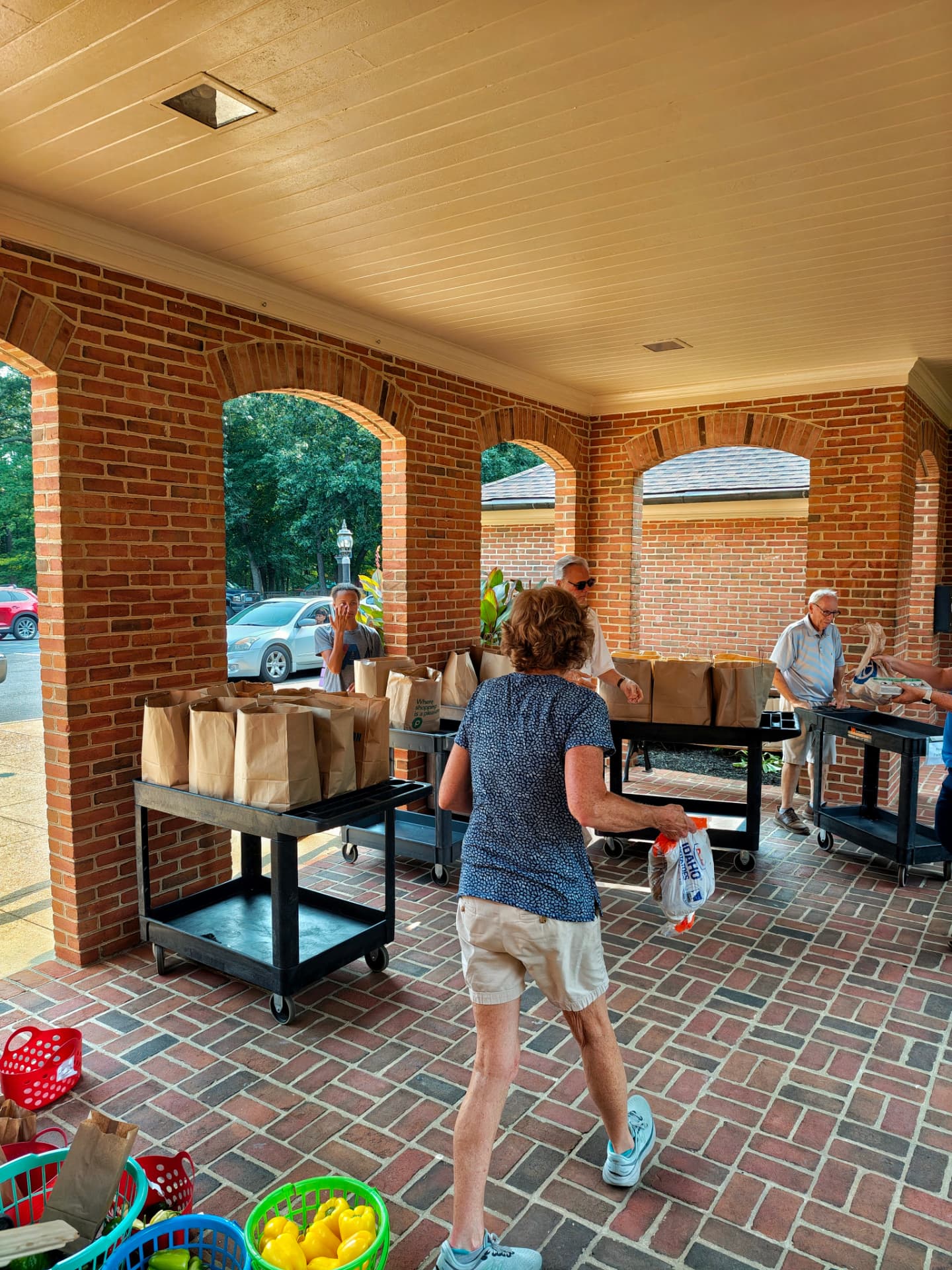 Volunteers distributing bags of groceries at the Welborne Community Food Pantry